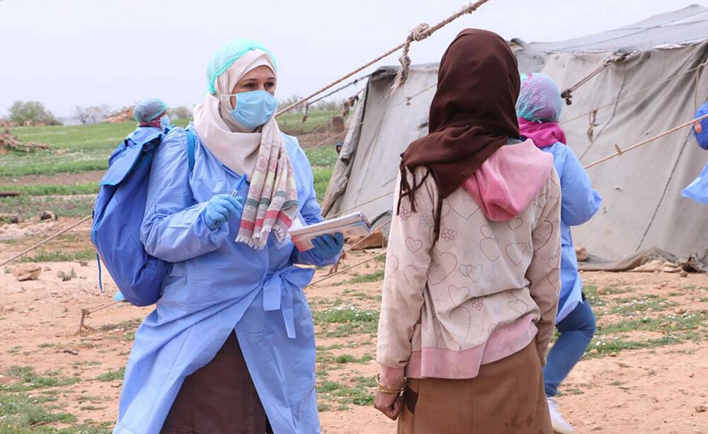 A healthcare worker assists a patient.