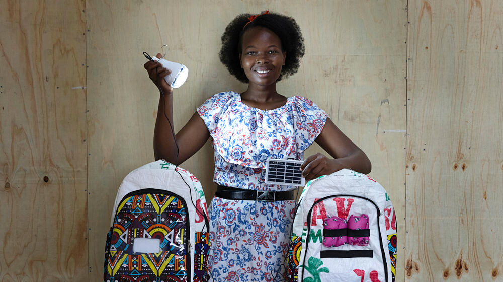 A young female engineer holds a solar-powered torch, one of many items included in the Smart Bags.