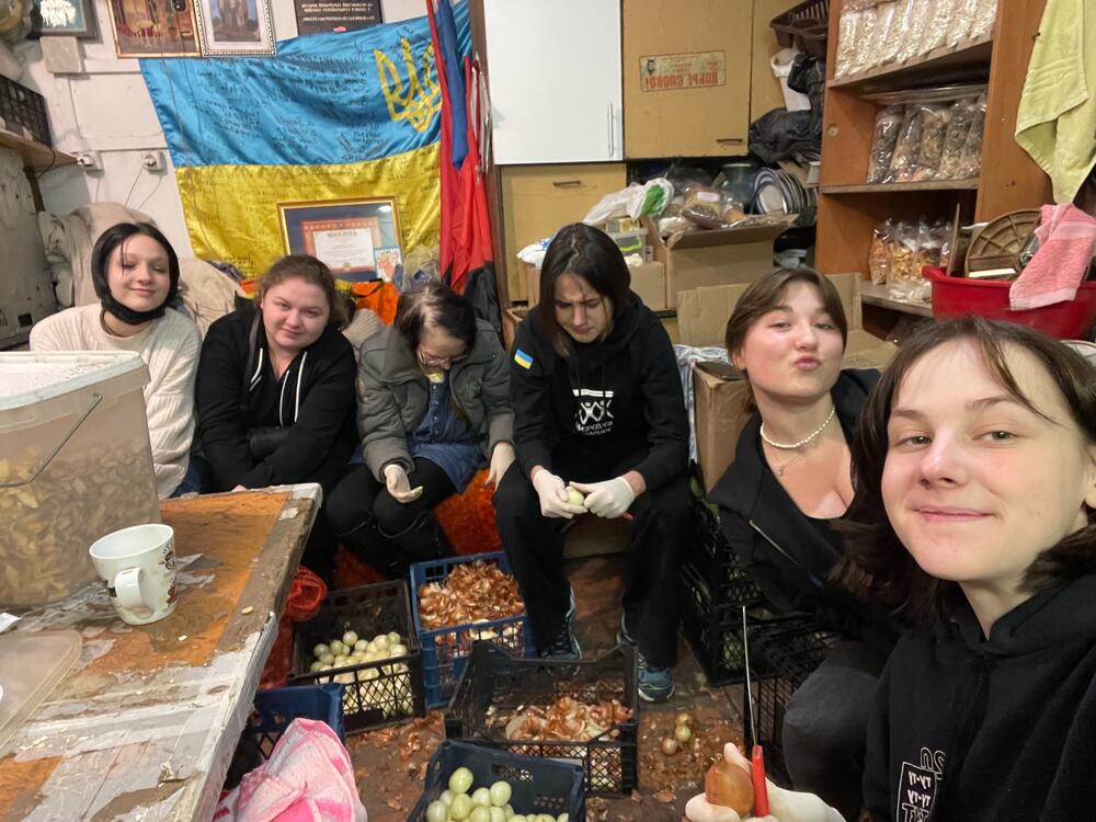 Girls peeling vegetables