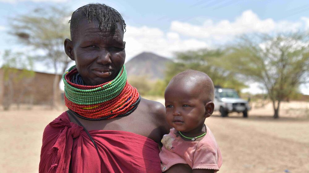 A woman holds her baby.