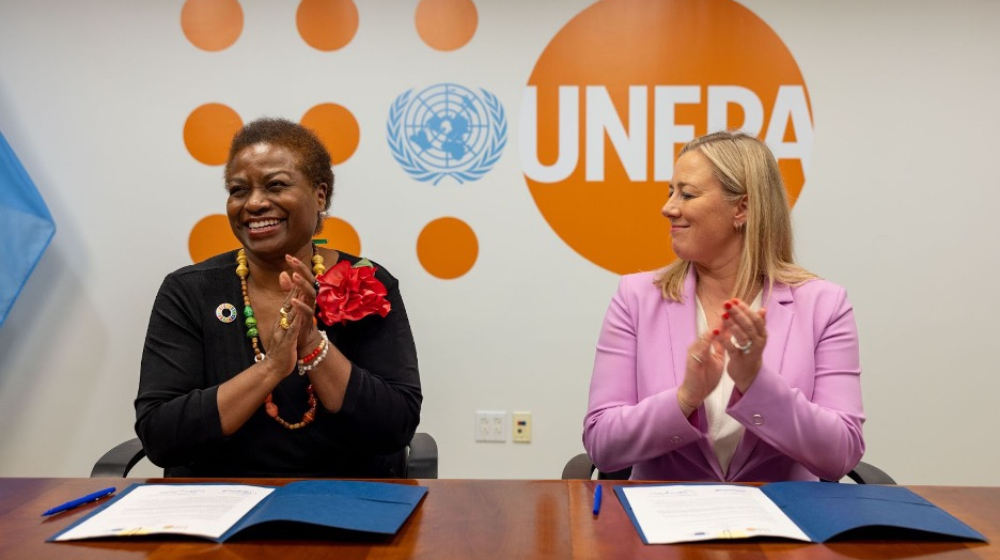 The Executive Director and EU Commissioner celebrate after signing an agreement.