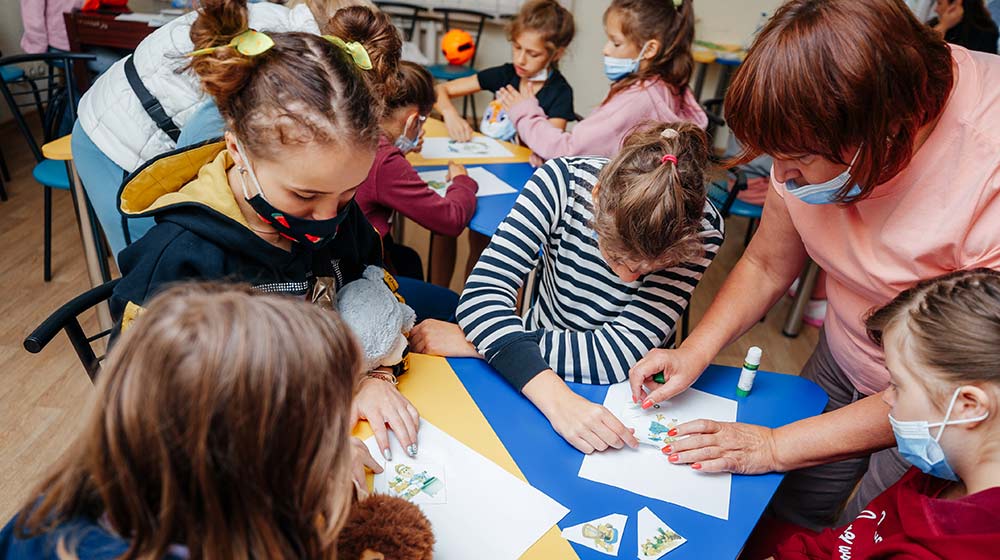 Children work together in an art class, part of efforts to empower adolescents with disabilities and promote inclusion.