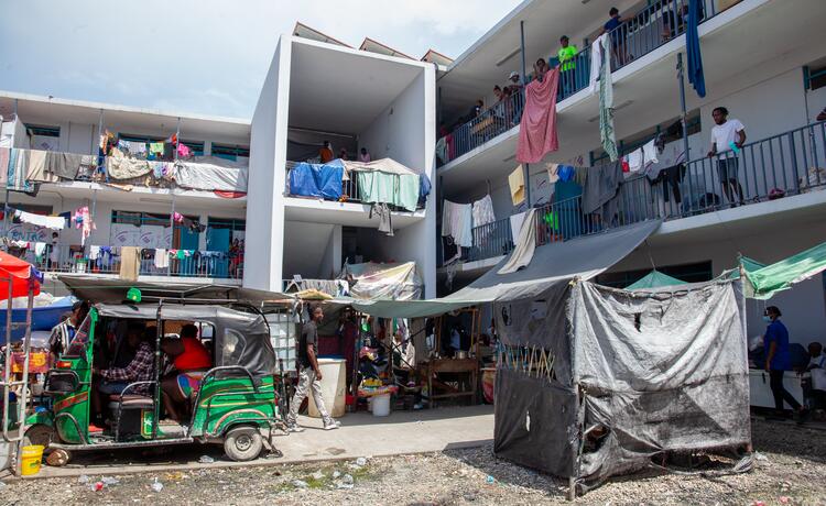 People with their belongings strewn across landings of a building