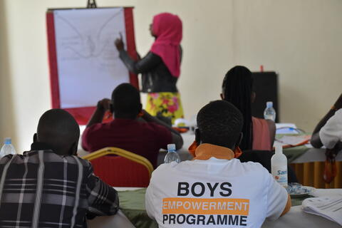 Young people sit for a training.