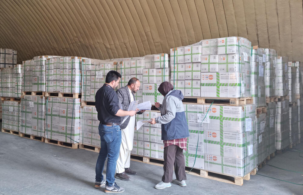 People inspecting health kit supply in warehouse