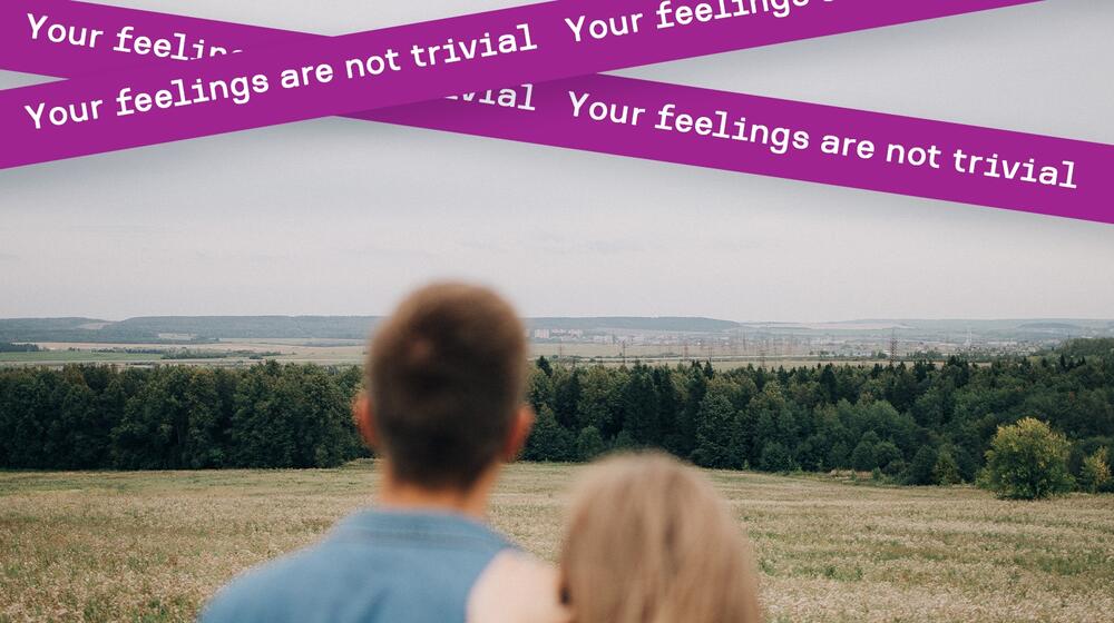 Two people look out over a field.