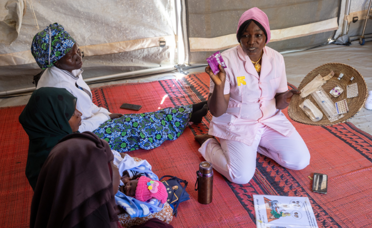 At a UNFPA-supported health centre for displaced women at the Farchana camp in Chad, midwife Maria Akouya informs Sudanese refugee women about the different kinds of contraception methods available © UNFPA Chad/Karel Prinsloo 