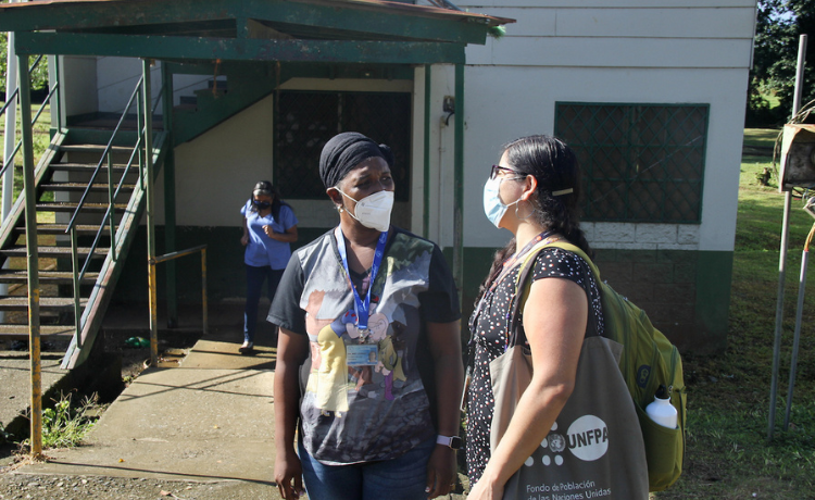  Two women talk outsider a small health centre