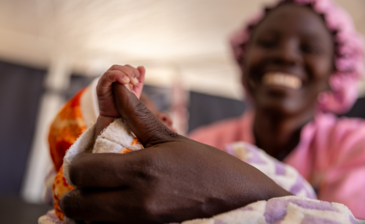 Woman smiling while holding baby