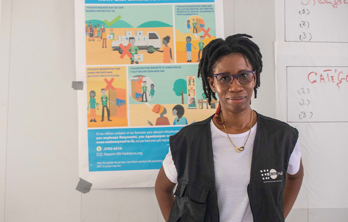 Taina Camy of UNFPA poses for a photograph. She is wearing a khaki vest.