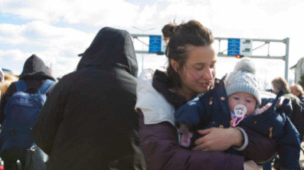 A woman holds a child.