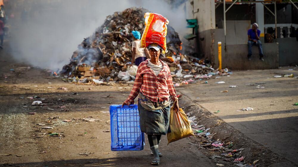 A woman walks in streets left empty by a general strike in Port-au-Prince, Haiti.