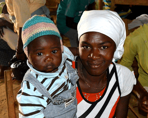 A woman holds her child.