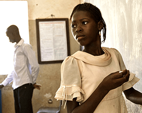 A girl stands at her classroom's blackboard.