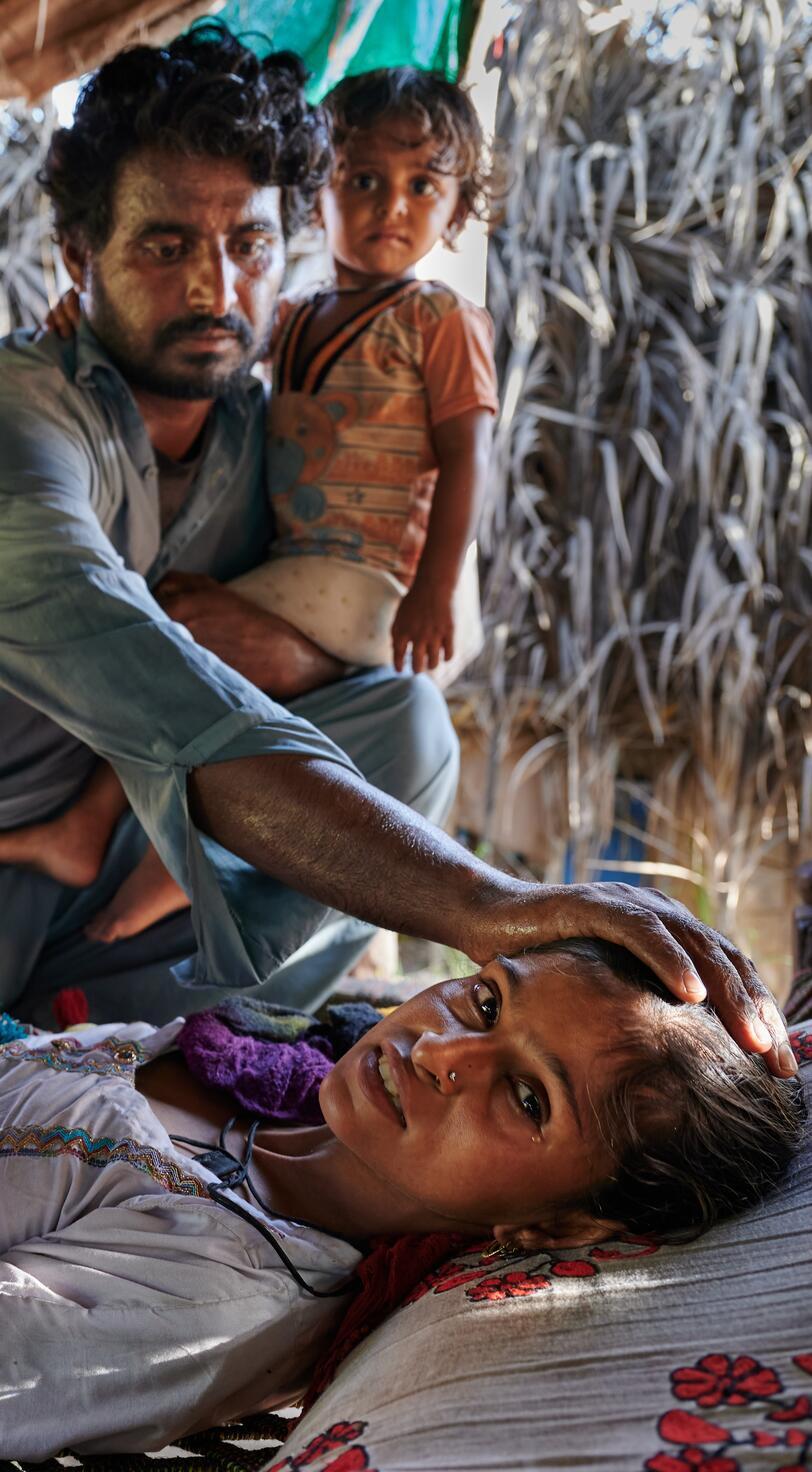 A man comforts a sick woman.