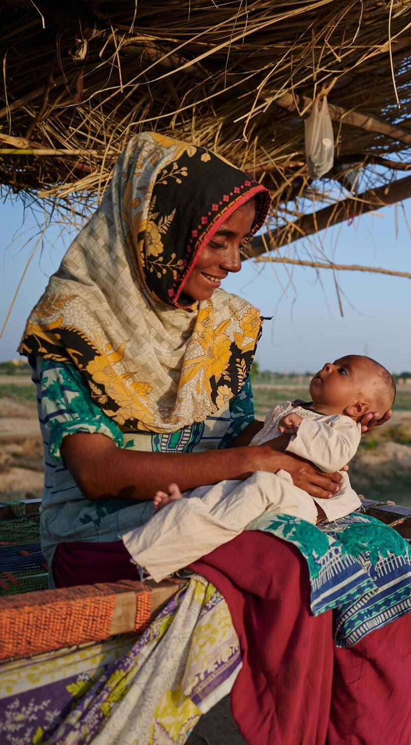 A woman holds her child.