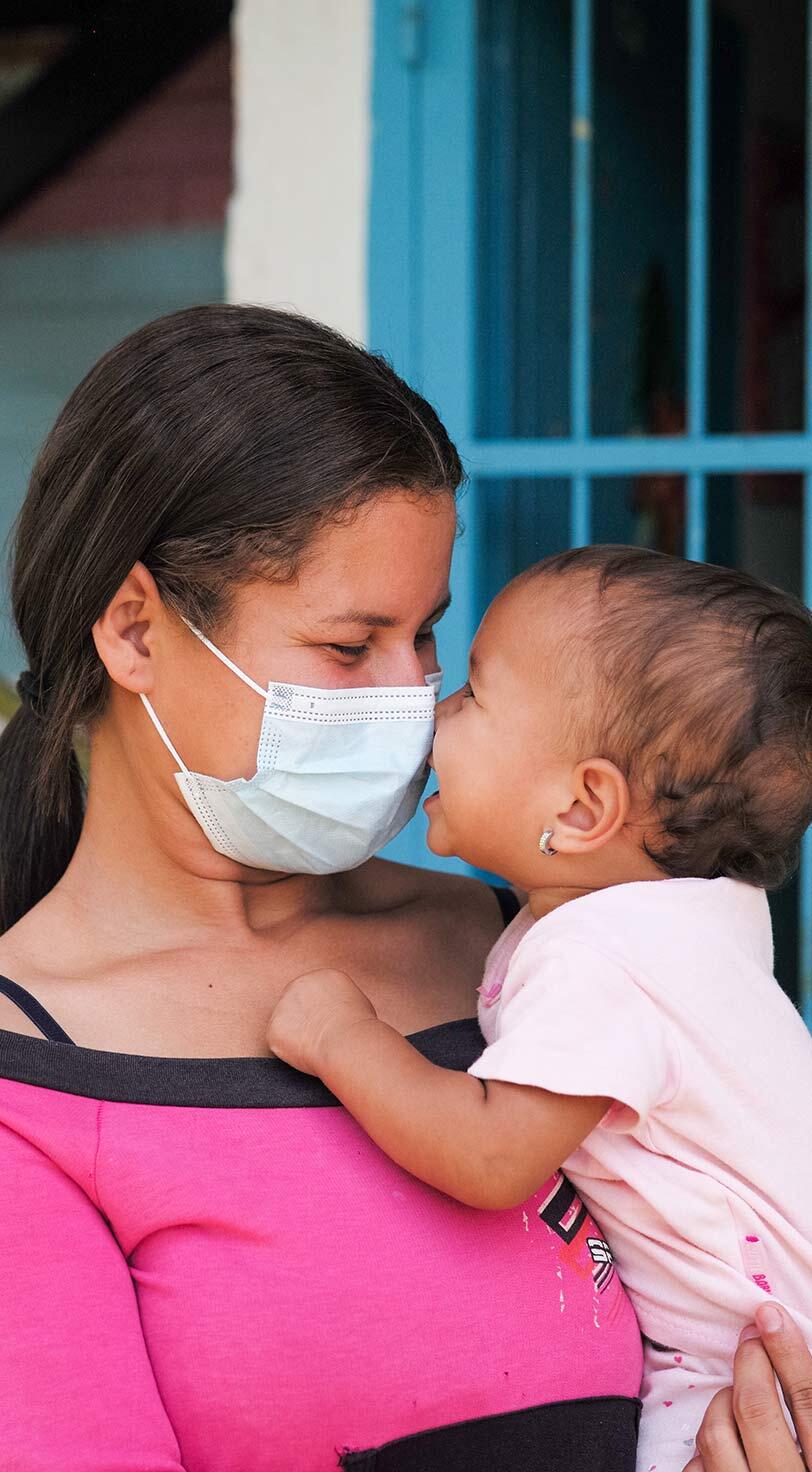 But one thing did not change this year: the tireless dedication of health workers, humanitarian workers, community leaders, grassroots advocates, educators and parents. Despite 12 months of turmoil, their ingenuity, spirit and hope continue to light the way to a brighter future. A young mother and child at a UNFPA-supported health centre in Turmero, Venezuela. 