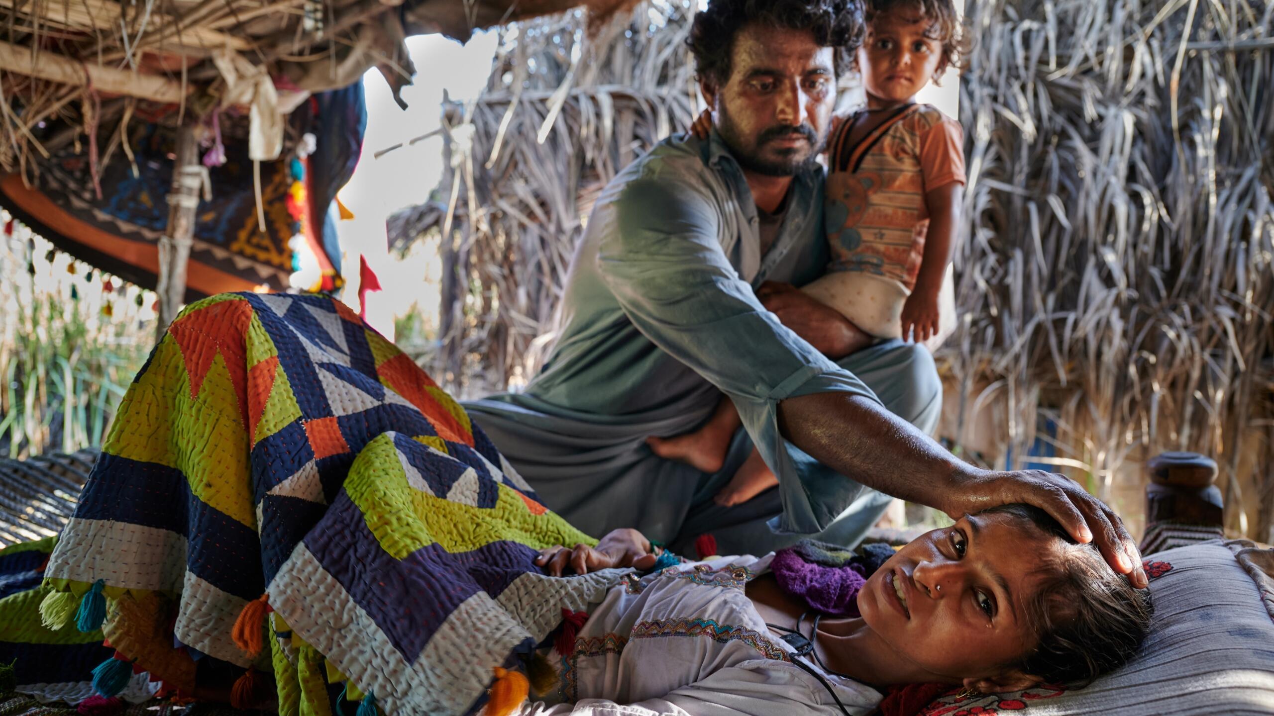 A man comforts a sick woman.