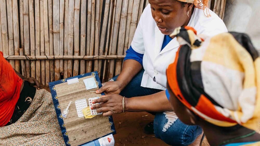 A medical worker teaches women about contraception.