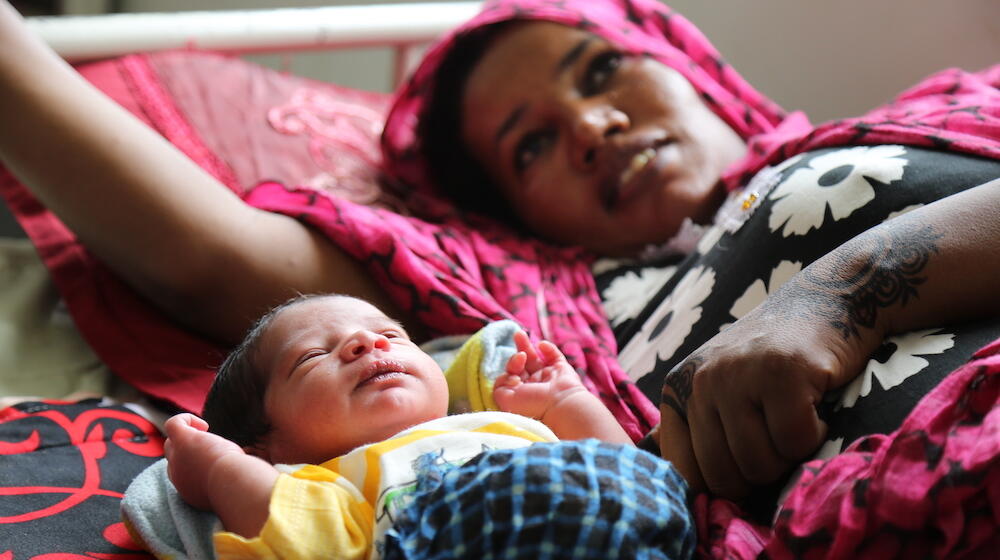 Mother and child laying next to each other. 